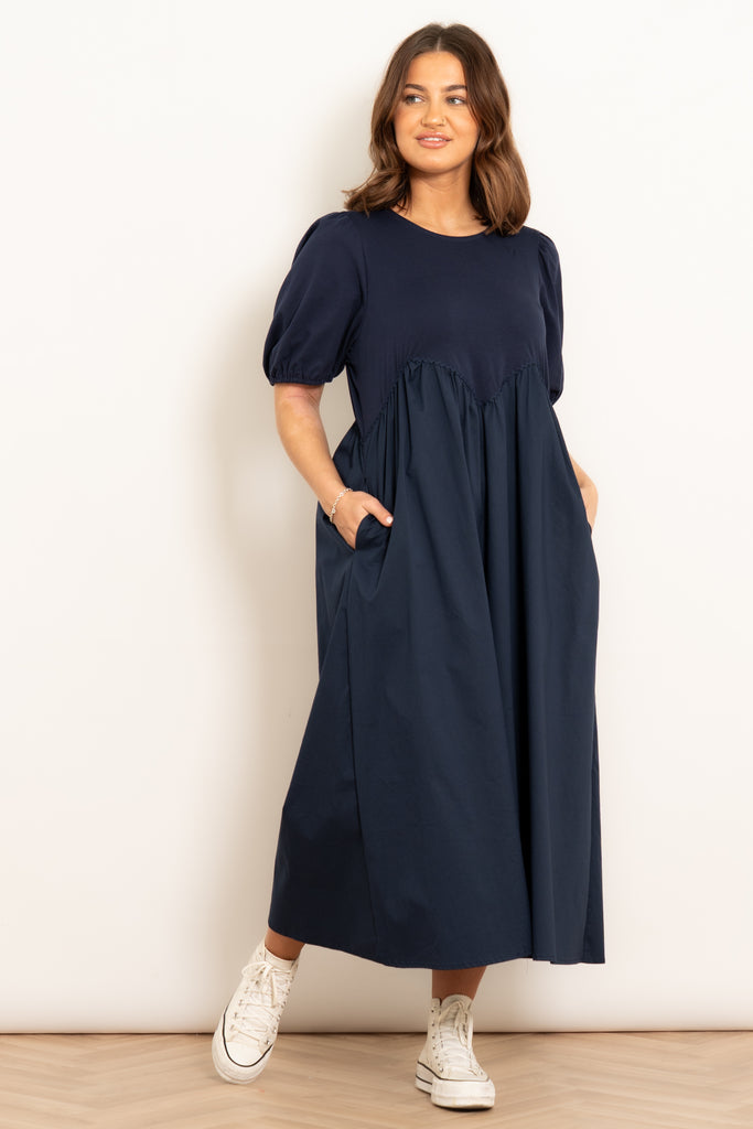 sawyer-cotton-midaxi-dress-navy-blue-jersey-mix-model-showing-side-pockets