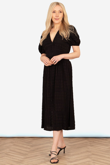 oliva-button-front-midi-tea-dress-black-asymmetric-stripe-styled-on-model-heeled-sandals