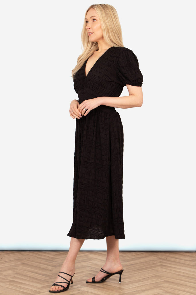 oliva-button-front-midi-tea-dress-black-asymmetric-stripe-side-view-short-sleeves
