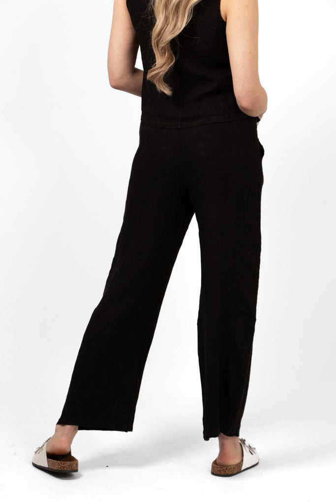 plain black trousers rear view shown on a model. wide leg design