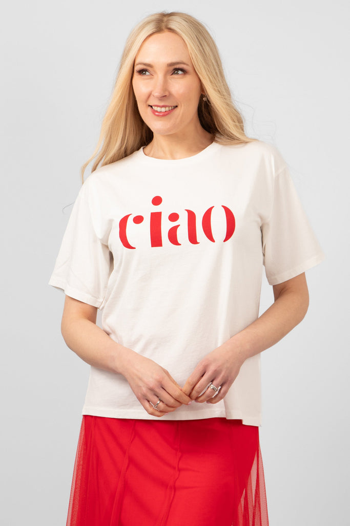 model wearing a white cotton t-shirt with a the word ciao printed boldly in red on the front. the t-shirt has a round neck and loose short sleeves