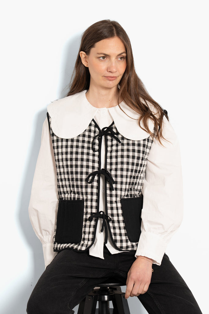 tabby-quilted-reversible-gilet-black-cream-gingham-model-front-view