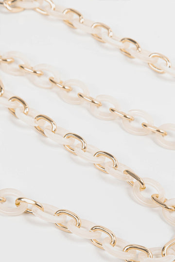 close up of the cream marbled oval link acrylic bag strap