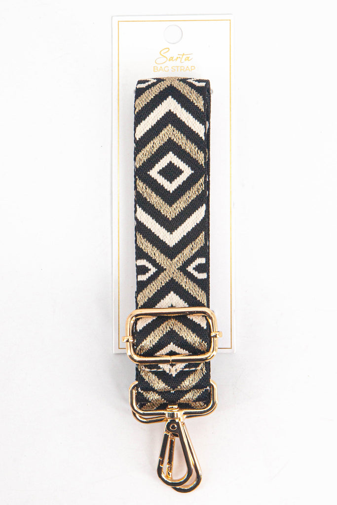 gold and black aztec pattern woven bag strap in its sarta packaging