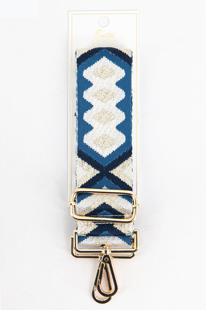 blue and gold aztec woven bag strap in its sarta packaging