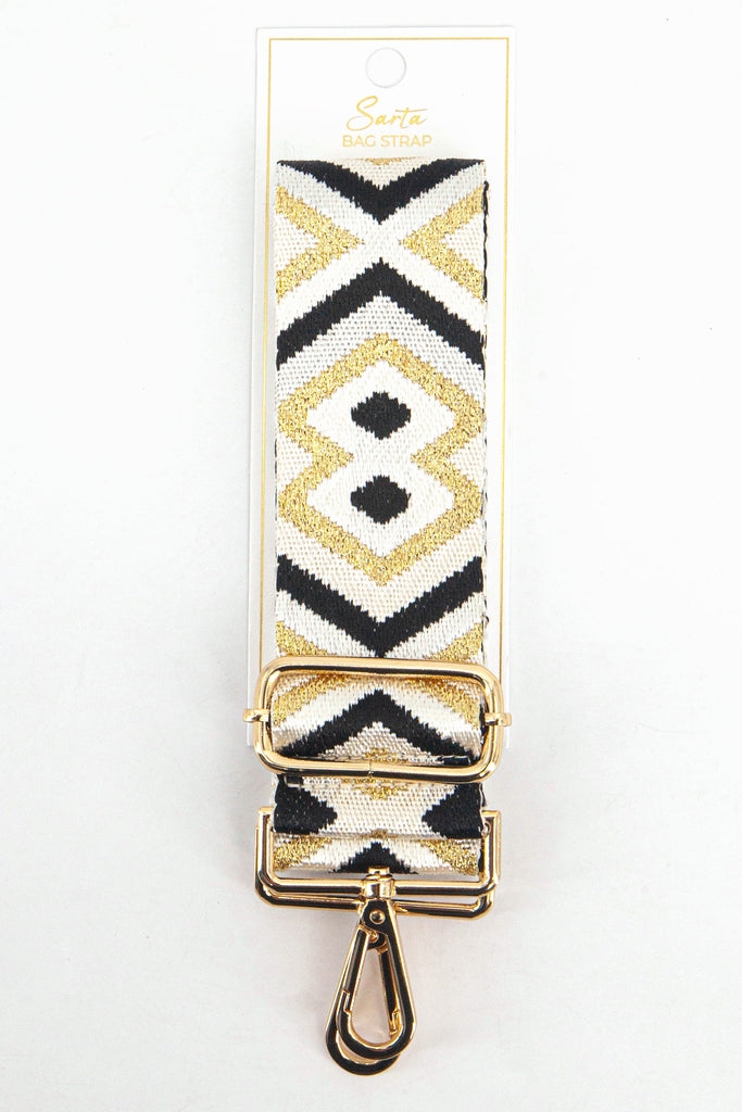 gold and black metallic aztec woven bag strap in its sarta packaging