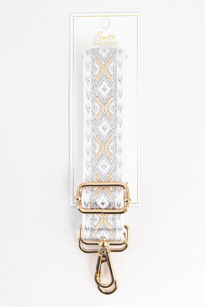silver and gold geometric woven bag strap in its sarta packaging