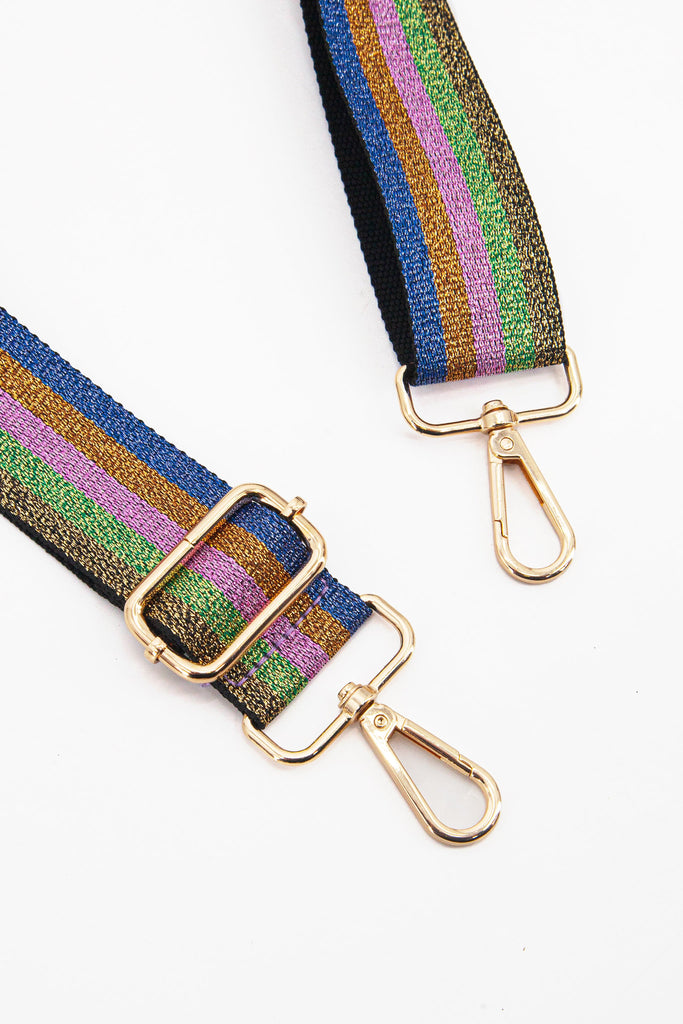 close up of the gold clip on snap hooks on the rainbow glitter striped bag strap