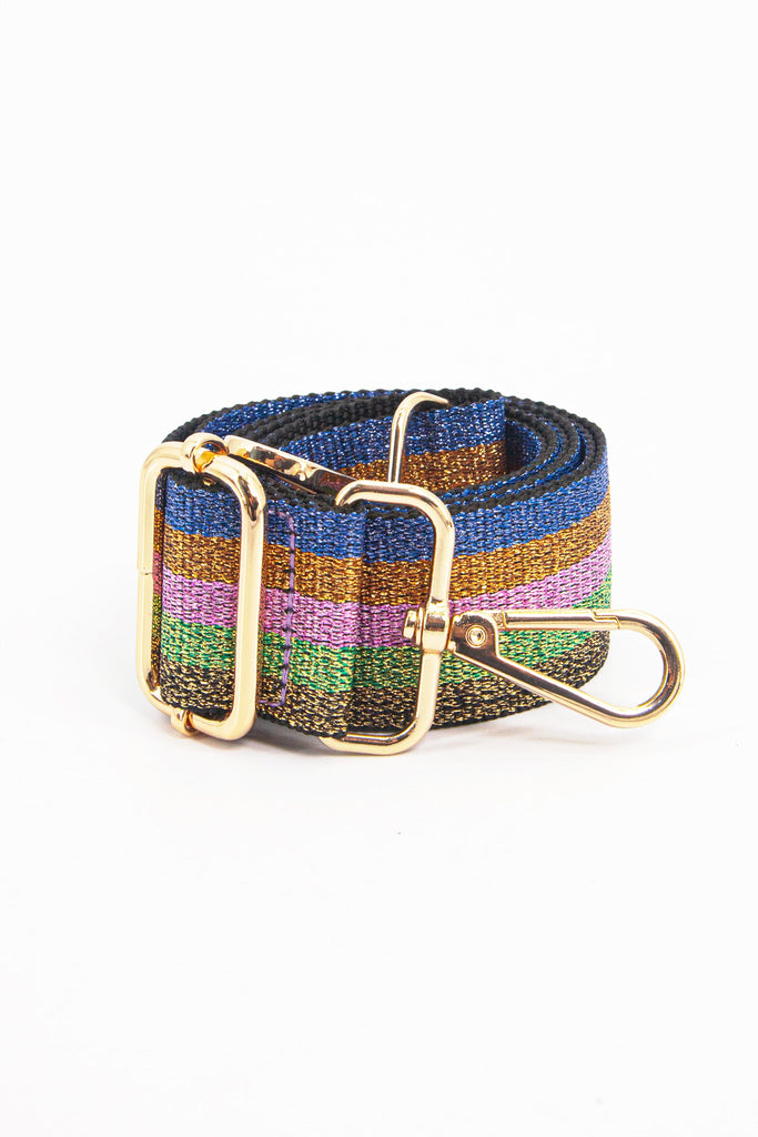 showing the rainbow glitter bag strap coiled around itself, the glitter sparkle and gold hard ware is clearly visible