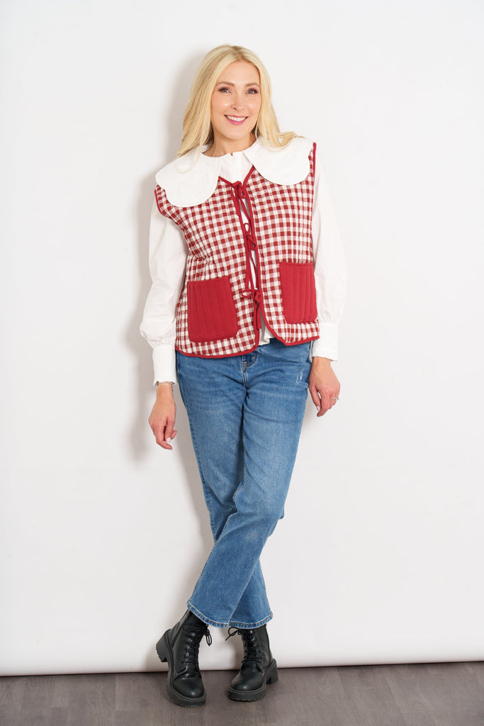 tabby-quilted-reversible-gilet-red-cream-gingham-styled-casually-model-jeans