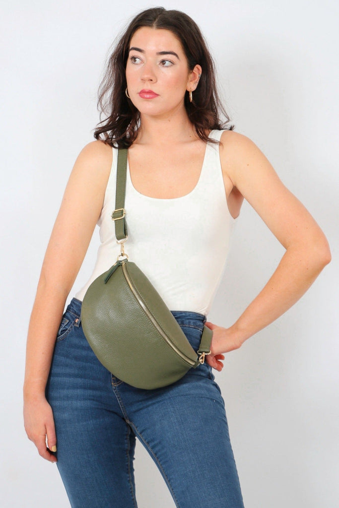 model wearing a large khaki green pebbled leather crossbody bag