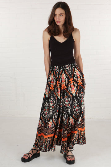 model wearing black and orange mandala print wide leg palazzo trousers