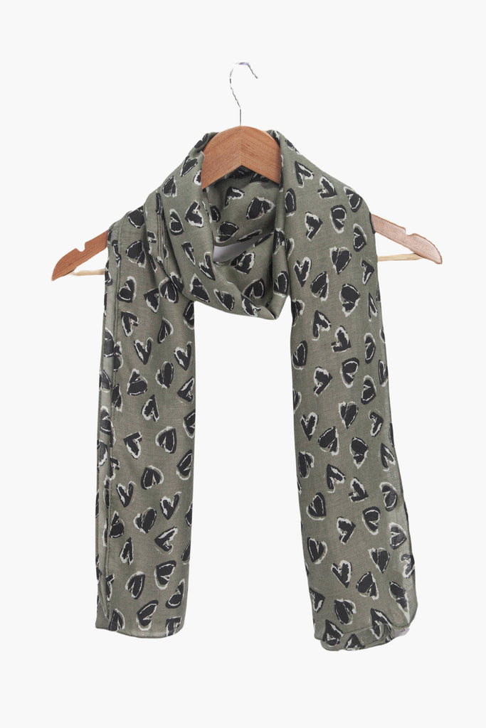 kara-khaki-black-hearts-lightweight-scarf-draped-on-coat-hanger