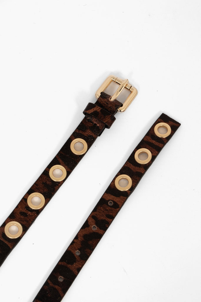 a skinny brown leopard print belt with gold coloured porthole fasternings and a gold buckle. the belt is made from pebbled italian leather.