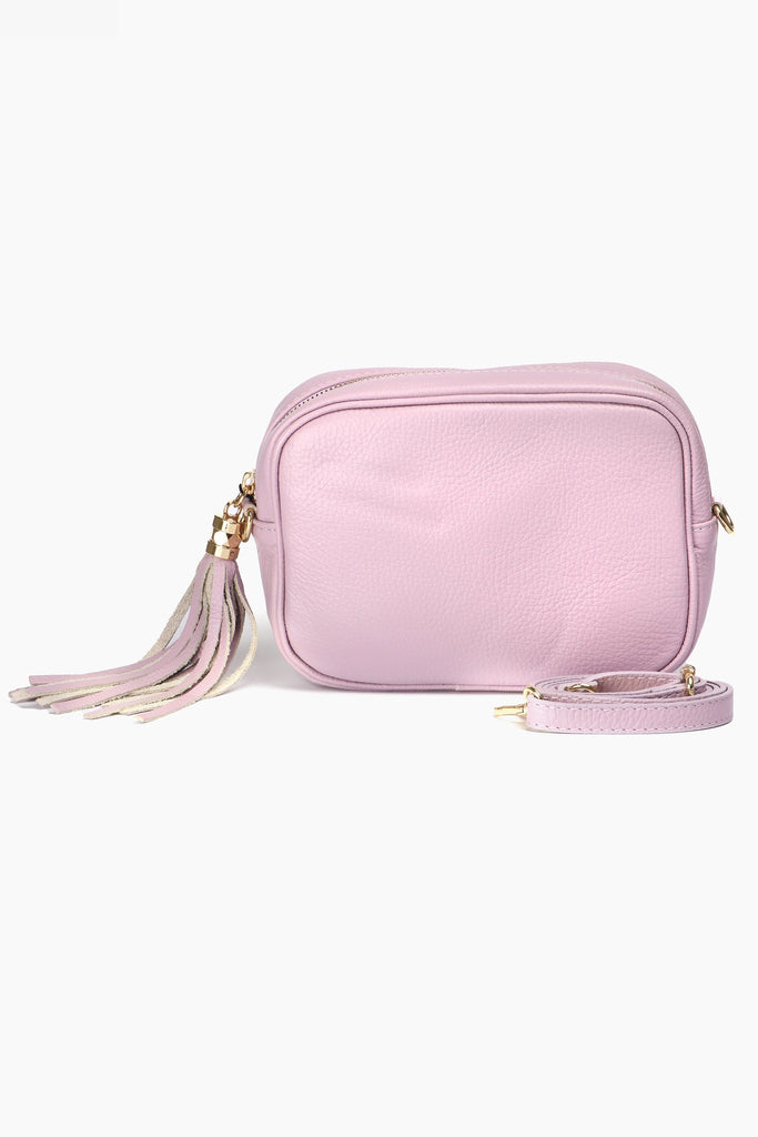 lilac crossbody camera bag with a decorative tassel and gold zip closure
