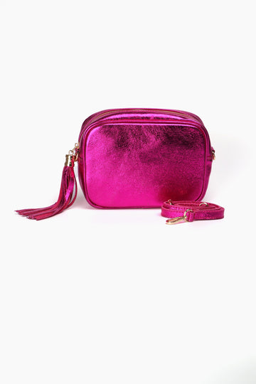 metallic pink crossbody camera bag in a metallic raspberry pink