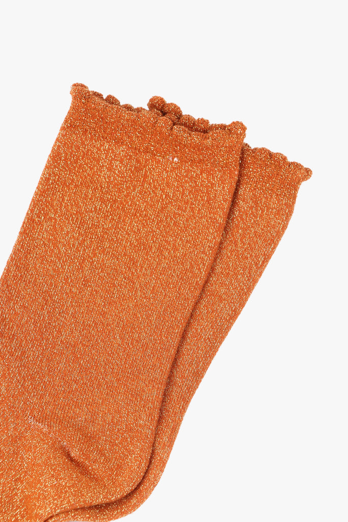 close up of the gold glitter sparkle on the orange socks