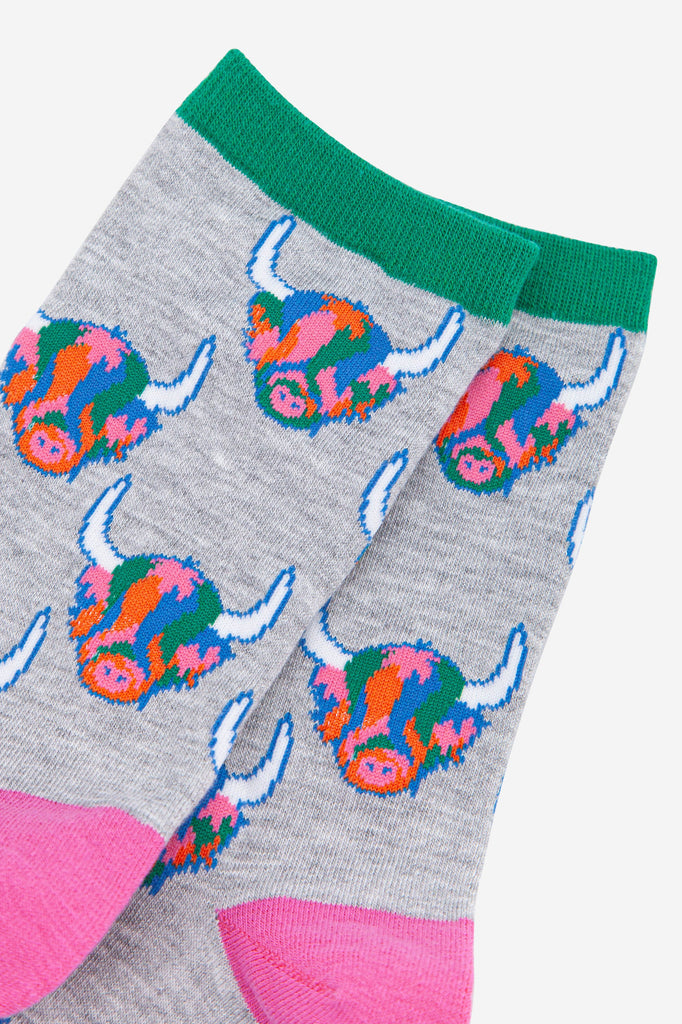 womens grey ankle socks with green cuff and pink heel with an all over pattern of multicoloured highland cow faces