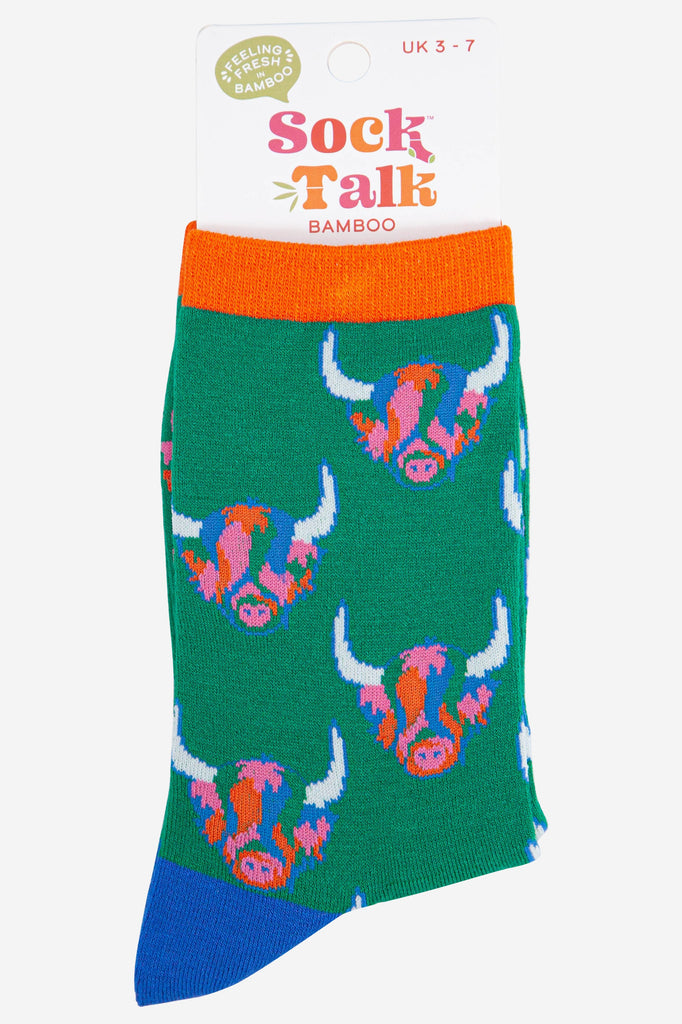 green bamboo ankle socks with an all over pattern of rainbow coloured highland cow faces