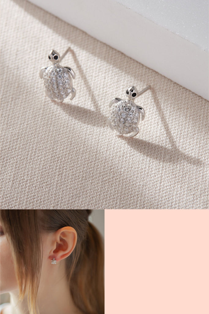 sterling silver stud earrings, designed to look like sea turtles, the turtle shells are encrusted with white sparkly cubic zirconia