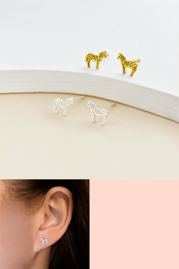 sterling silver tiny zebra stud earrings in gold and silver, the zebra stripes are represented by small grooves on the earrings