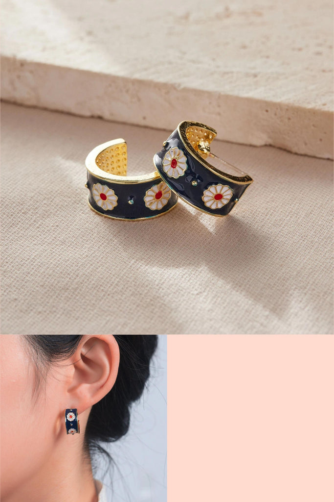 blue enamel plated half hoop earrings with a white daisy floral pattern