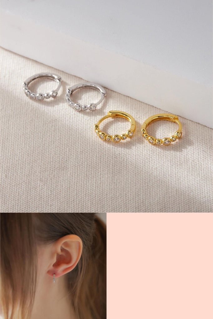 silver and gold 8mm huggie hoop earrings, each with seven cz bead studs on the outer rim of the earrings giving them a sparkly effect