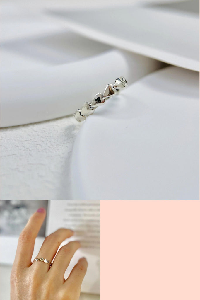 sterling silver open ring designed to look like a chain of solid silver love hearts