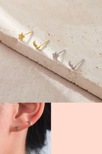 gold and silver coloured sterling silver stud earrings, each pair has one crescent moon stud and one five pointed star stud earring. the surface of the studs are textured and look like a zebra print pattern