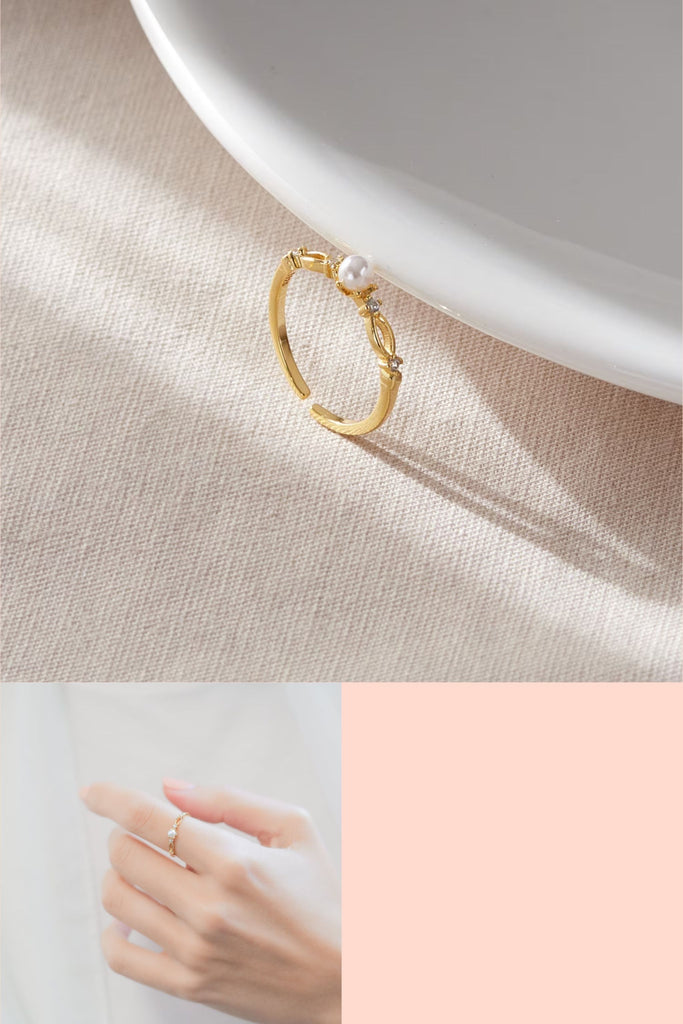 gold plated sterling silver open ring with a faux pearl in the centre and four small white cubic zirconia crystal accents on the rim of the ring