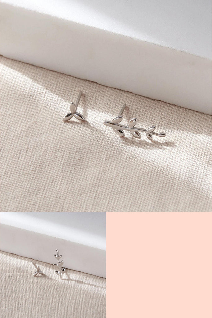 asymmetrical stud earrings in sterling silver, one small leaf stud and one larger leaf stud