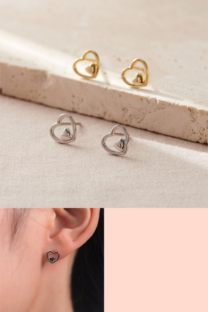 sterling silver openwork stud earrings, a design featuring a small solid heart surrounded by a larger open love heart, earrings have butterfly backs