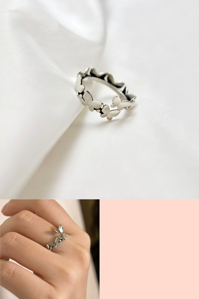 sterling silver adjustable open ring, design features nine small butterflies together in a row, the ring is made from S925 sterling silver 