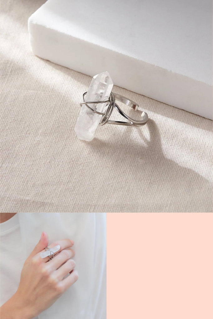 silver coloured copper ring with a large white rouugh ct crystal mounted in the middle.