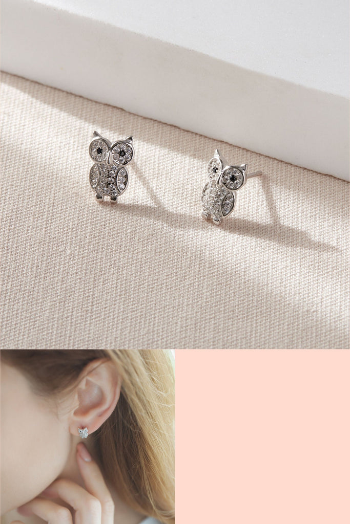 sterling silver and white cz owl shaped stud earrings which have an all over sparkly effect, the studs have butterfly backs