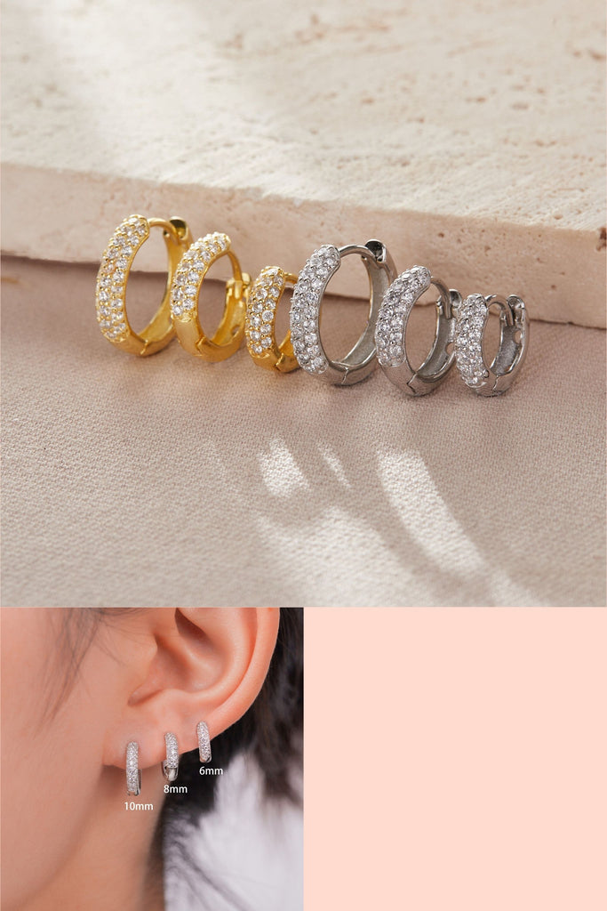 three sizes of sparkly huggie hoop earrings, 6mm ,8mm and 10mm available in silver and gold. the hoops are made from sterling silver and are encrusted with white sparkly cz on the cuffs