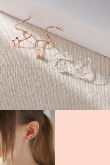 silver and rose gold spiral star earrings, they feed through the earlobe and wrap around the ear cuff like climber earrings