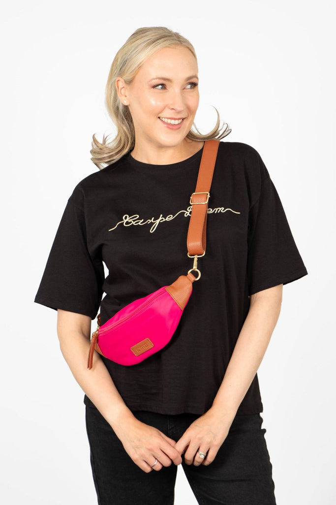 Blonde model wearing pink nylon and pu crossbody bum bag
