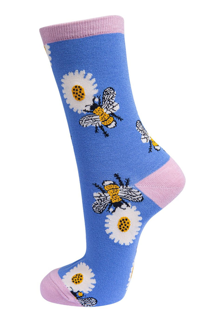 lilac and pink socks with a pattern of large bees and daisy flowers