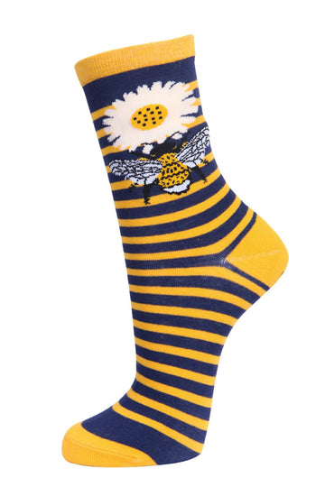 yellow and navy blue striped socks with a large bee and daisy flower on the ankle