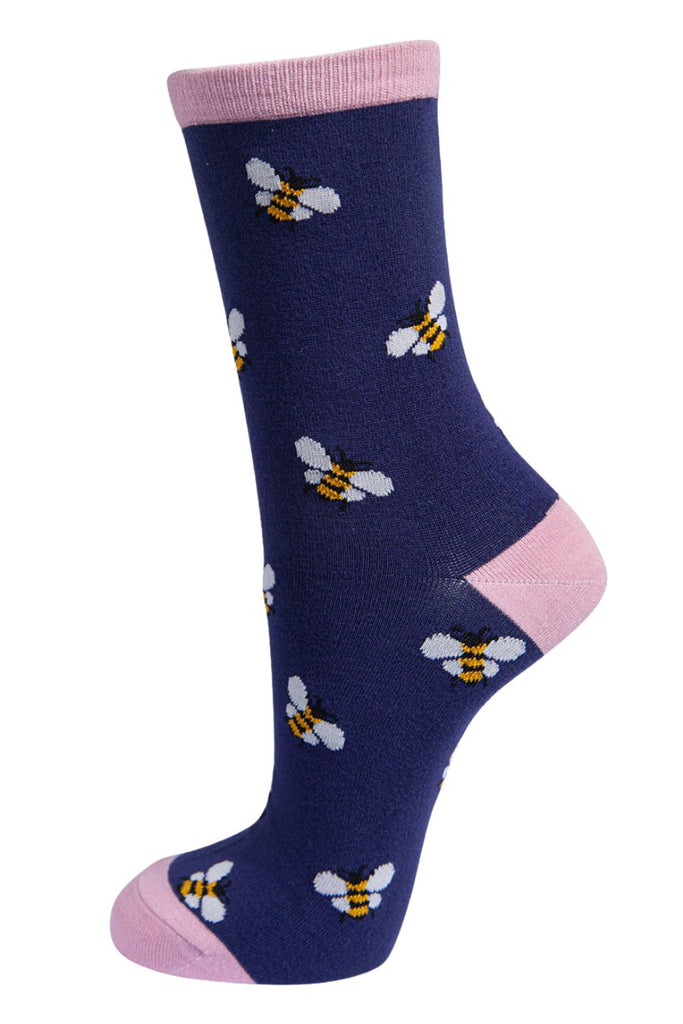 navy blue socks with pastel pink heel, toe and cuff with an all over pattern of yellow bumblebees