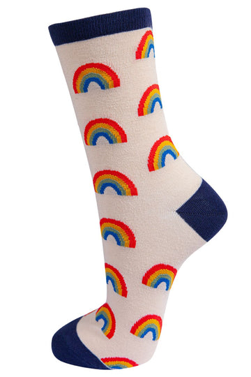 cream socks with navy blue heel, toe and cuff with an all over multicoloured rainbow pattern