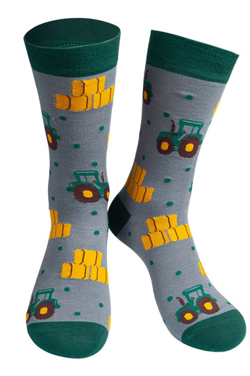 grey socks with green heel, toe and trim with an all over pattern of green tractors and bales of hay