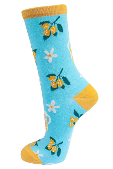 blue socks with a pattern of lemon fruit and flowers and jugs of lemonade