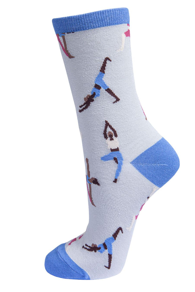 light grey socks with a contrasting blue heel, toe and cuff with an all over pattern of people doing yoga poses