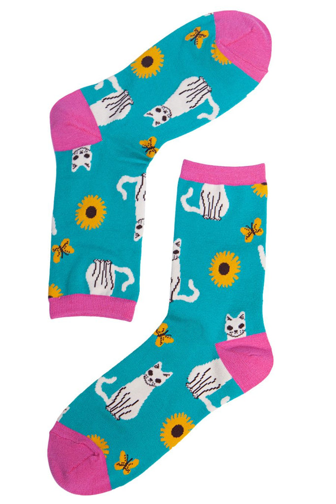 blue and pink socks with a pattern of sunflowers and cats