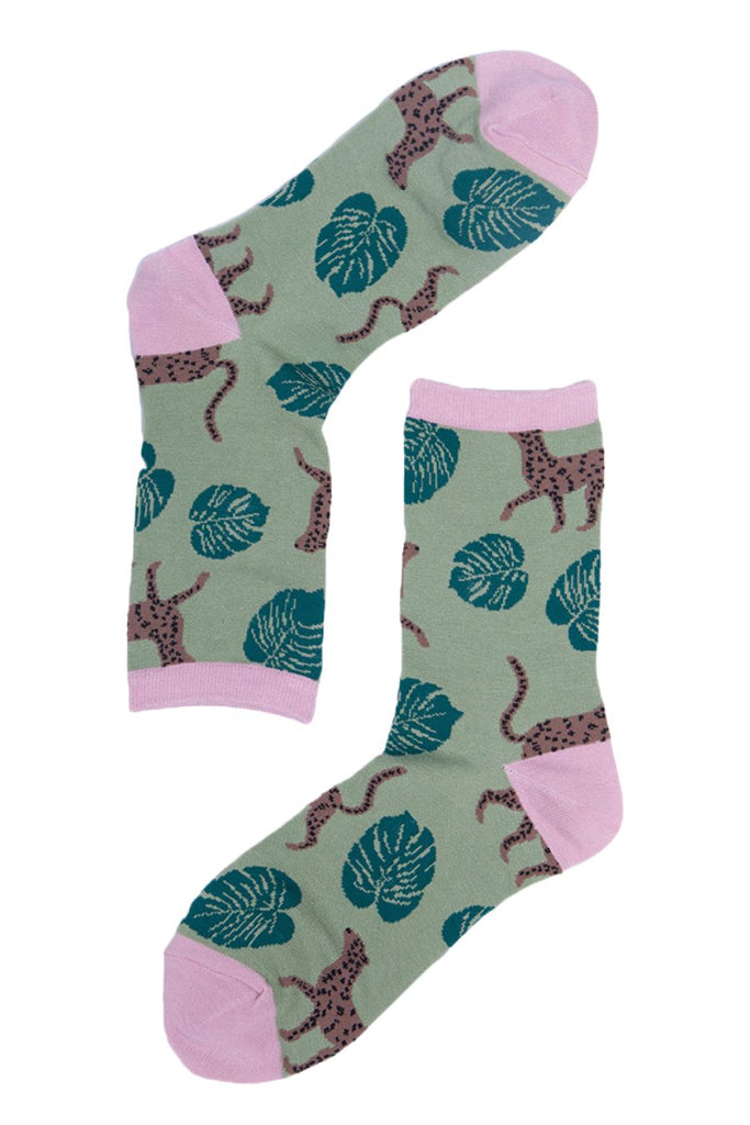 close up of the cheetah and leaf print pattern on the green ankle socks