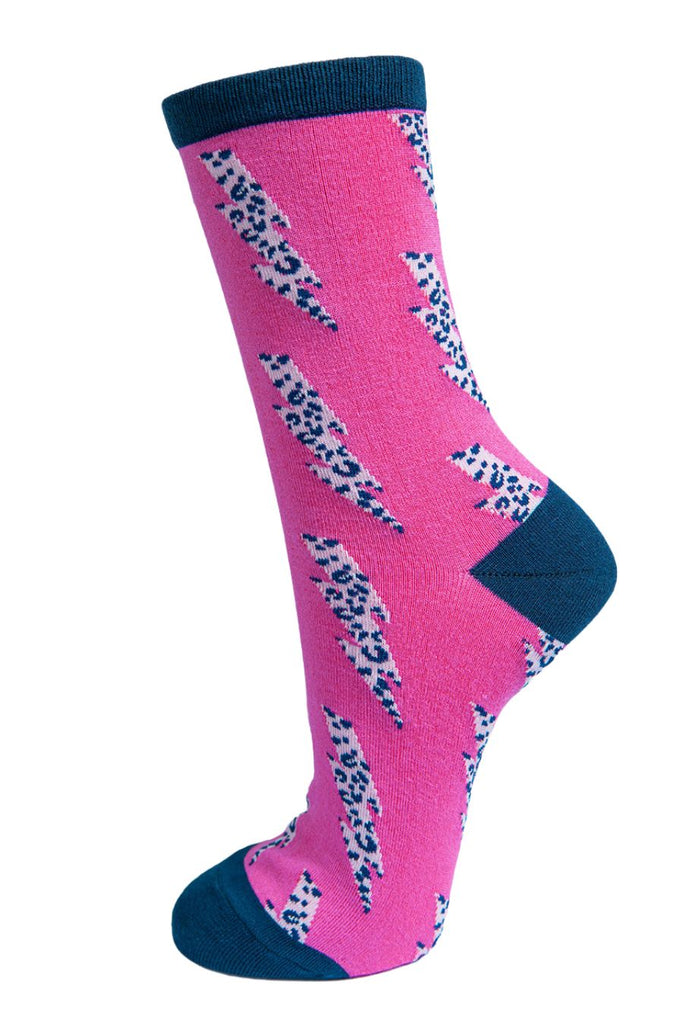 pink ankle socks with navy blue heel, toe and cuff with a white and navy blue leopard print lightning bolt pattern