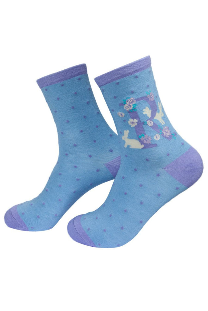 bluesocks with a large letter r, a white rabbit and a floral pattern on the ankle