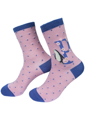 pink socks with a large letter p, a penguin and a floral pattern on the ankle